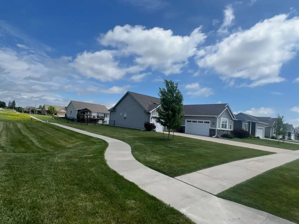 Lawn mowing, trimming, and edging completed at a residential home off North James Street in Grimes, IA.